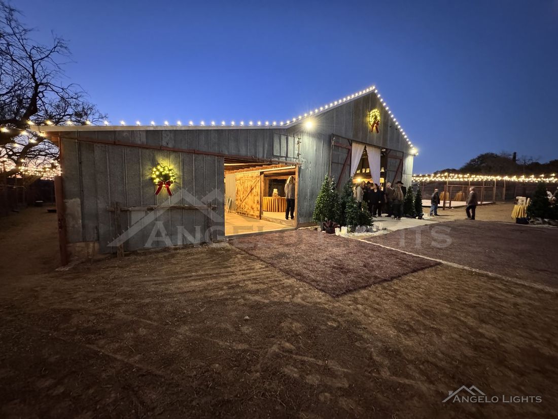 Barn outlined in lights at blue hour