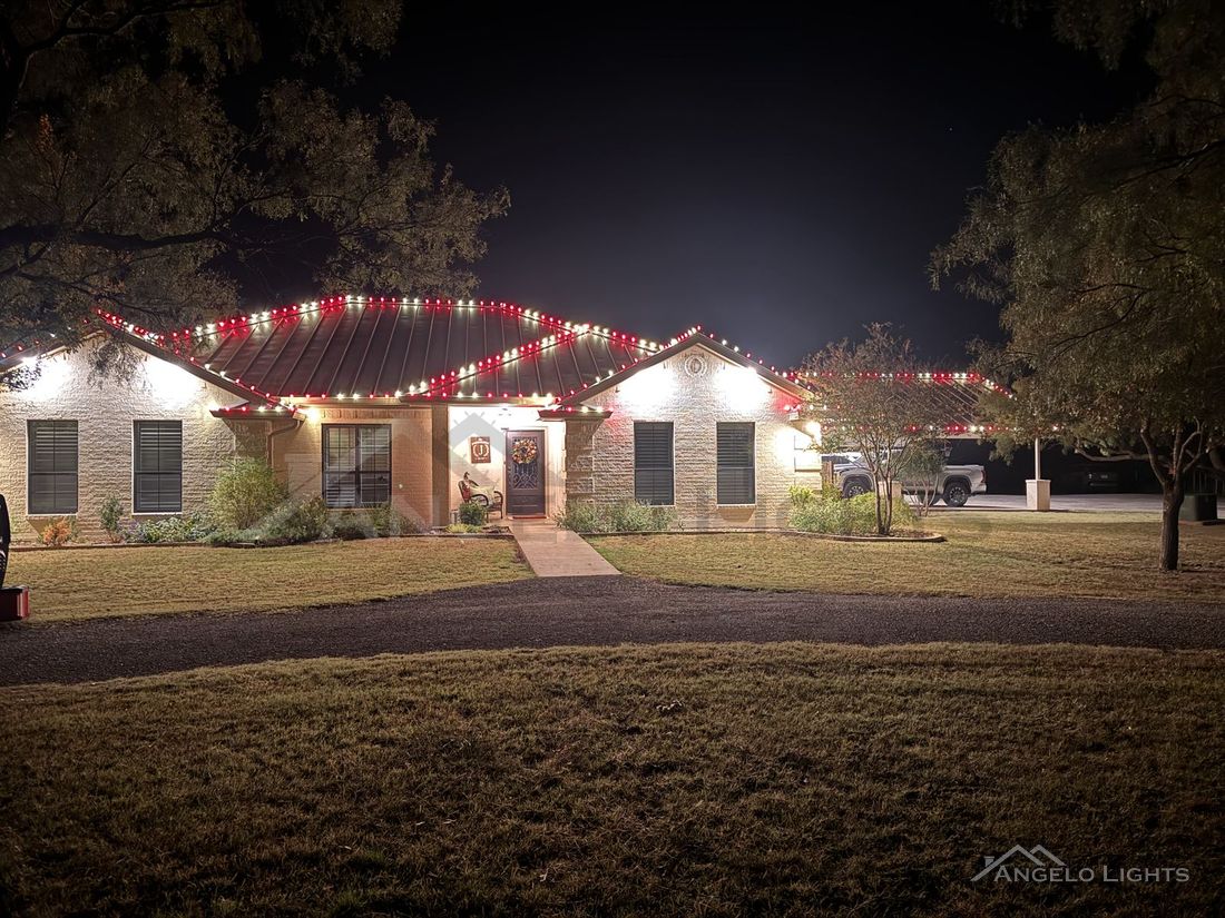 Red and white permanent lights along a roofline