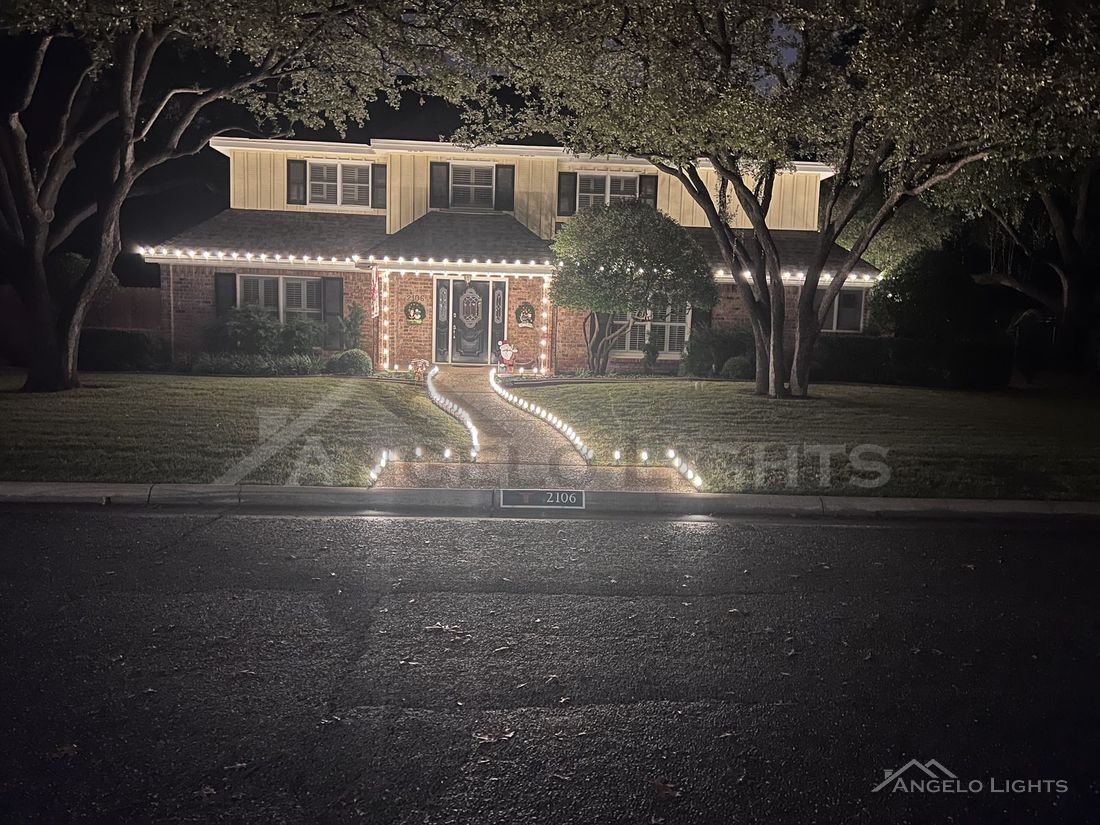 Two-story home with roofline and walkway lights